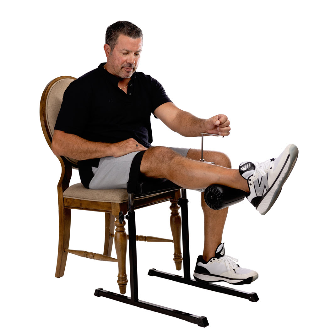 Man using seated leg extension exercise machine