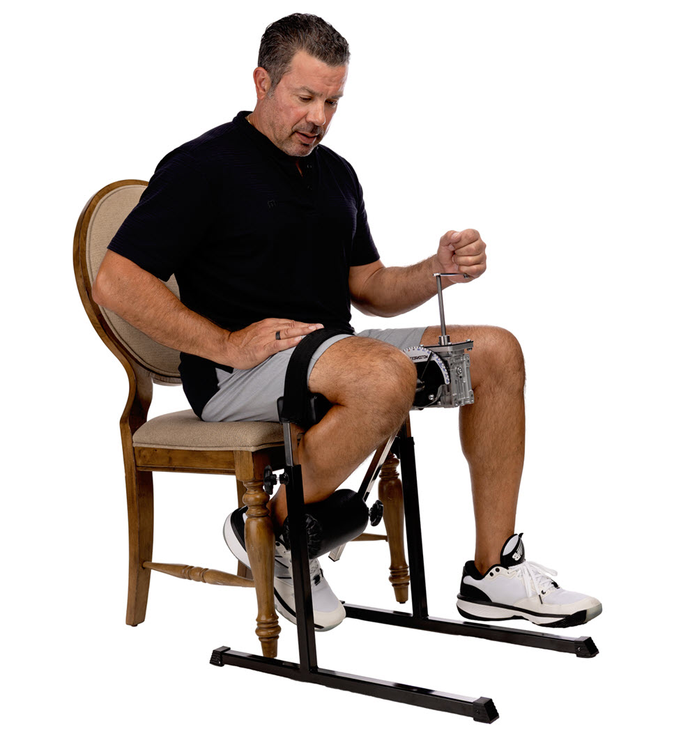 Man using seated leg exercise machine