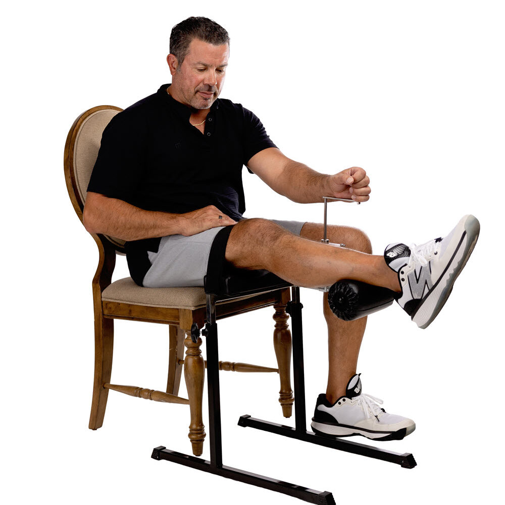 Man using seated leg extension exercise machine
