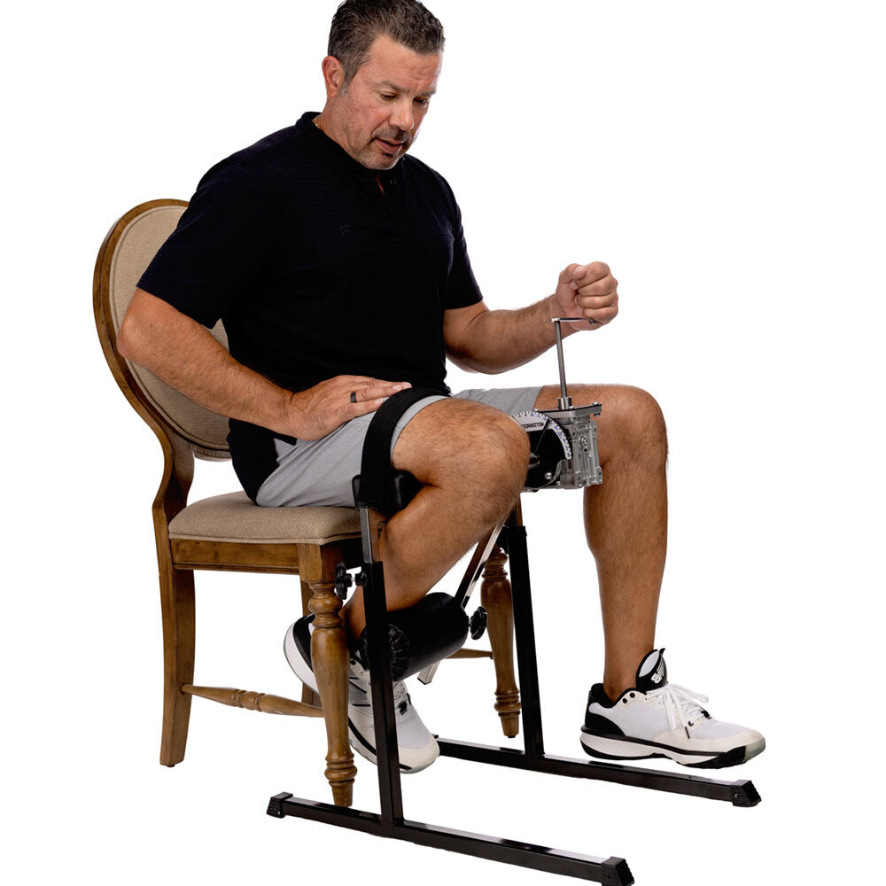 Man using seated leg exercise machine